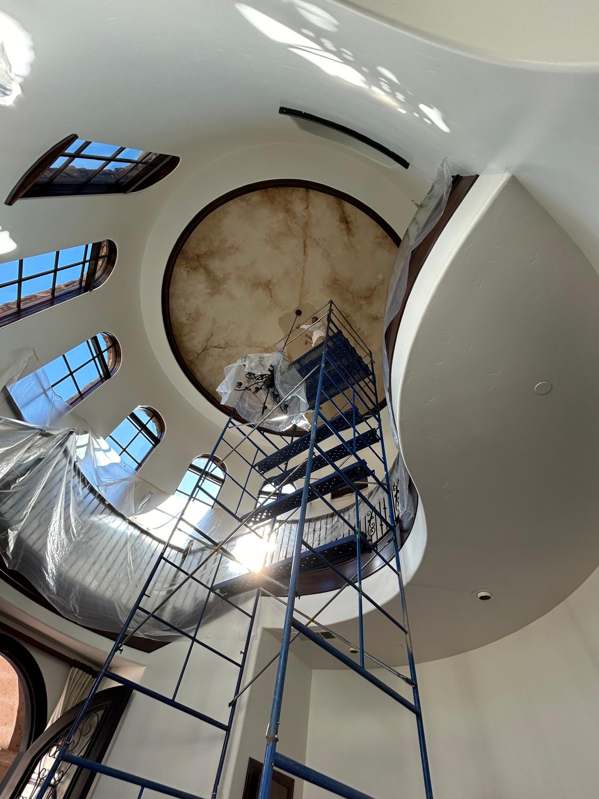 Protected curved stairway during a detailed painting project